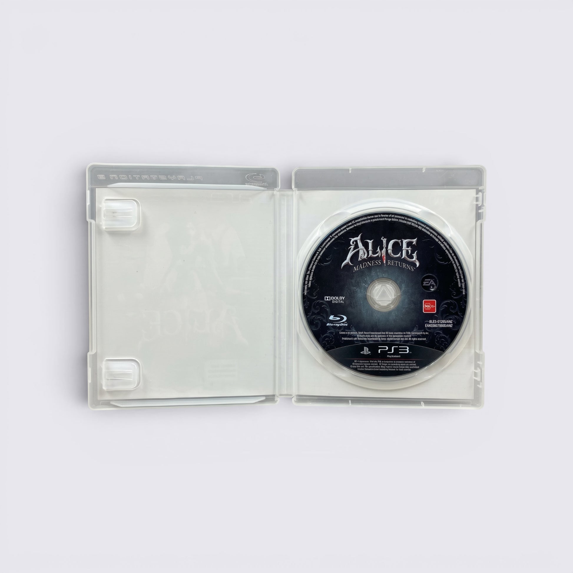 MrPixel Alice: Madness Returns PS3 game disc inside an open clear plastic case featuring gothic branding.