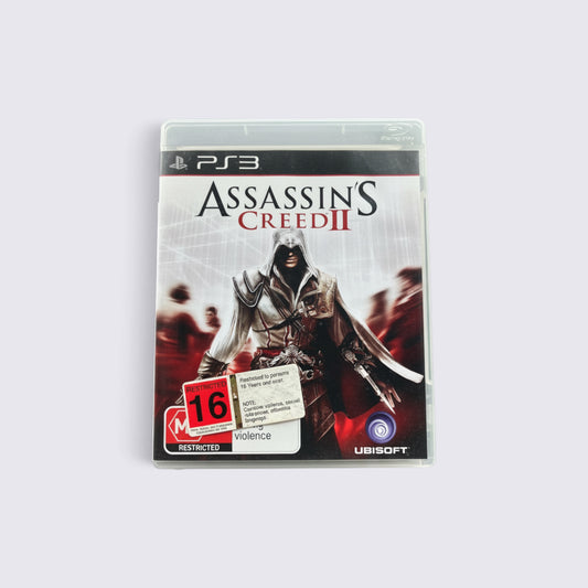 MrPixel Assassin's Creed II PlayStation 3 game case featuring Ezio Auditore on the cover with a 16+ rating sticker.