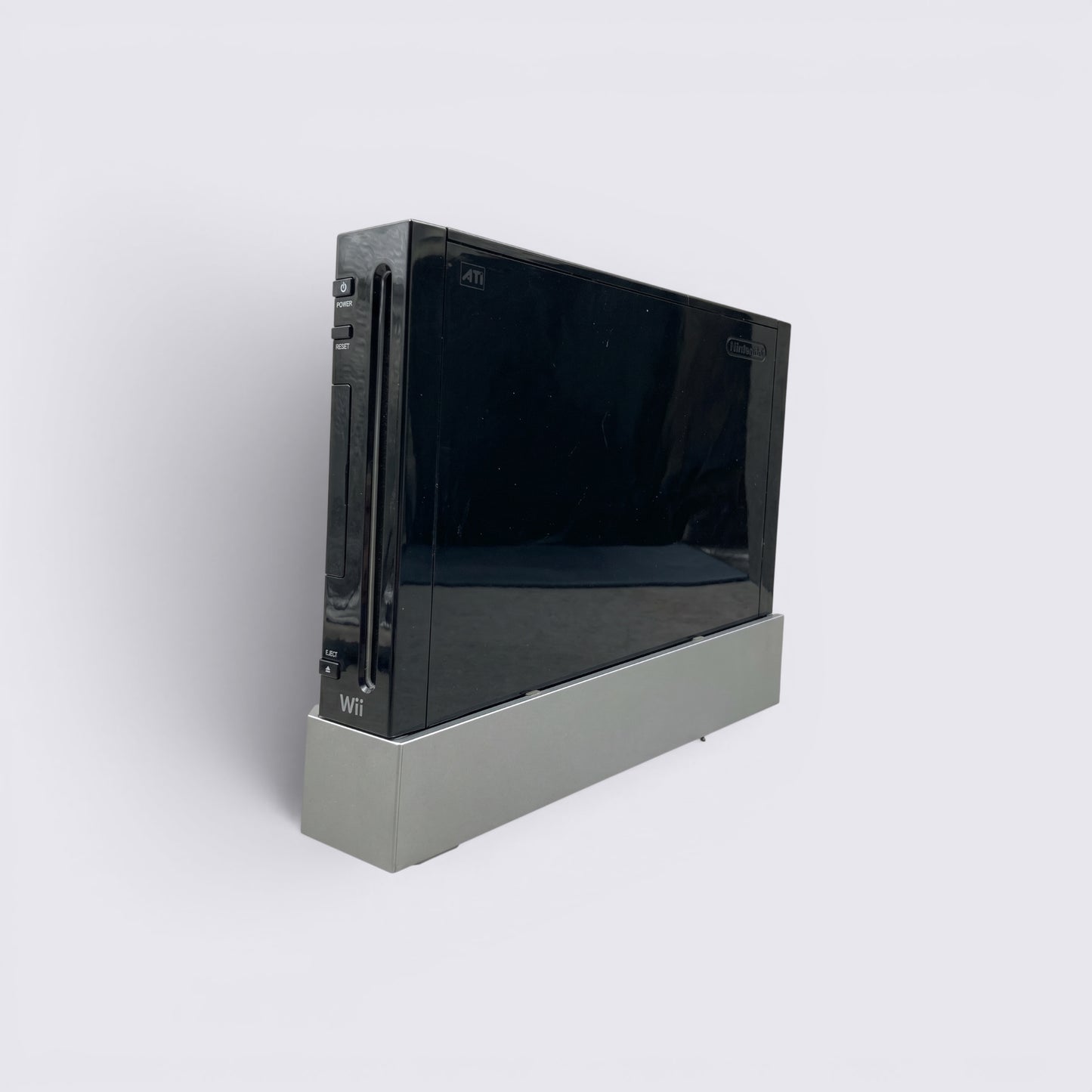MrPixel black Nintendo Wii home gaming console standing vertically on a grey stand against a neutral background.