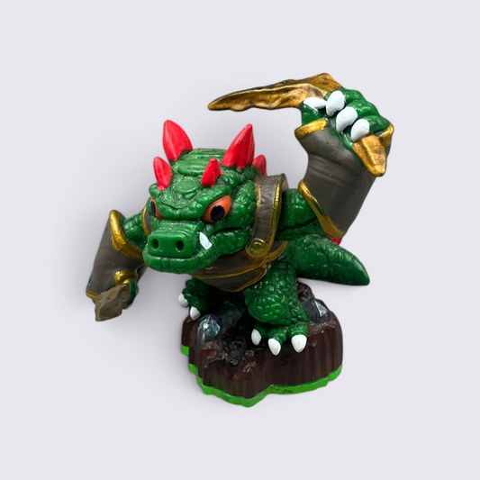 MrPixel Dino-Rang Skylander figure with green scales, red spikes, and gold boomerangs on a rocky earth base