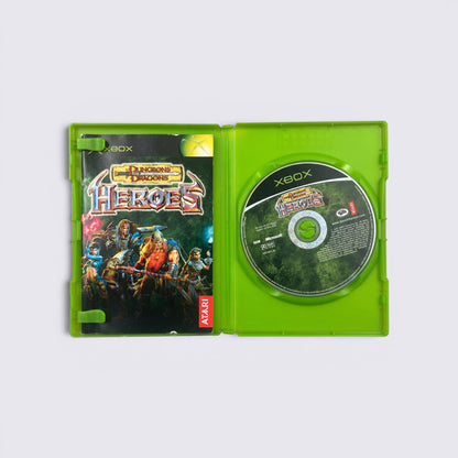 MrPixel Dungeons & Dragons: Heroes Xbox game case open with manual and game disc inside on a grey surface.