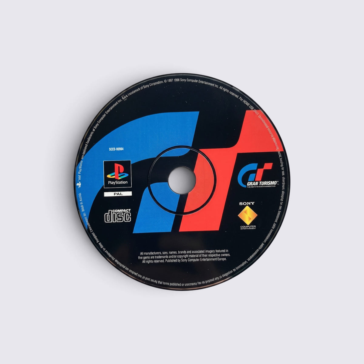 MrPixel Gran Turismo PlayStation game disc featuring the iconic red and blue GT logo on a black background
