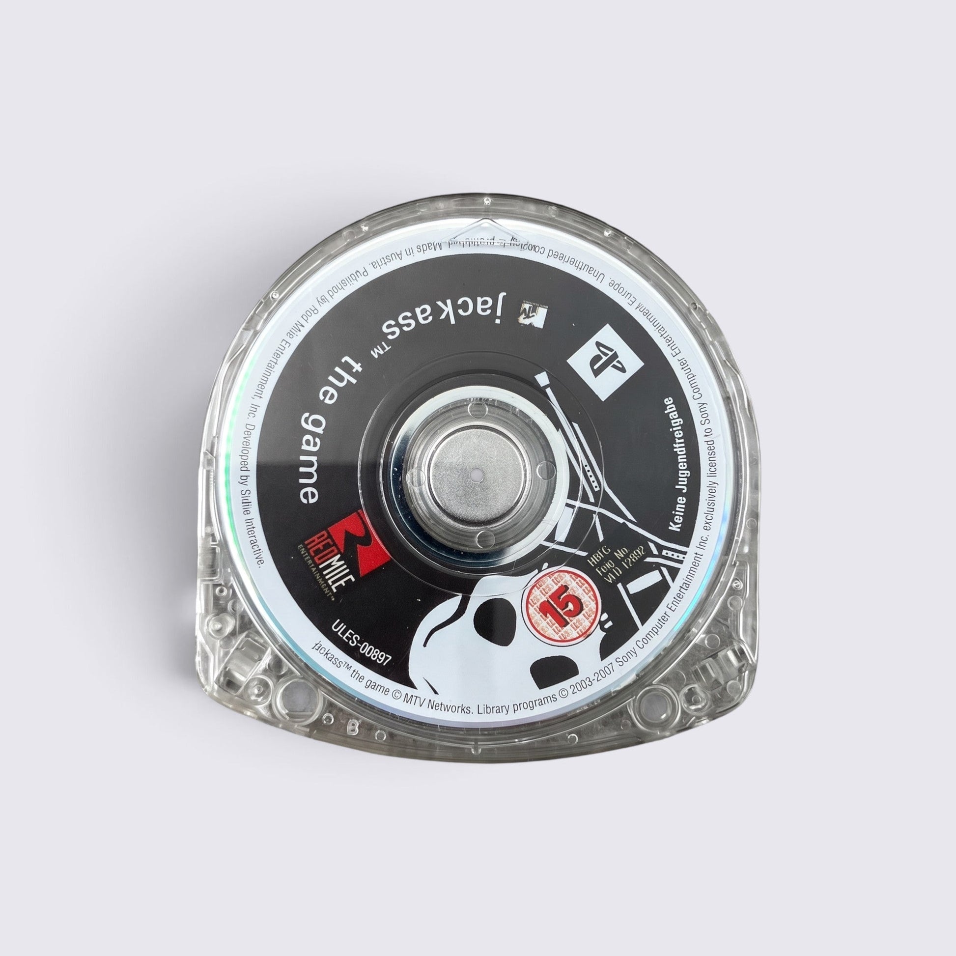 MrPixel Jackass The Game UMD disc for PlayStation Portable featuring the iconic skull logo on a clear plastic case.