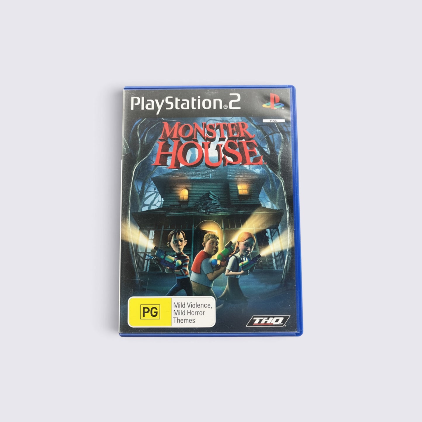 MrPixel Monster House PlayStation 2 game case featuring the main characters with toy blasters in front of a house.