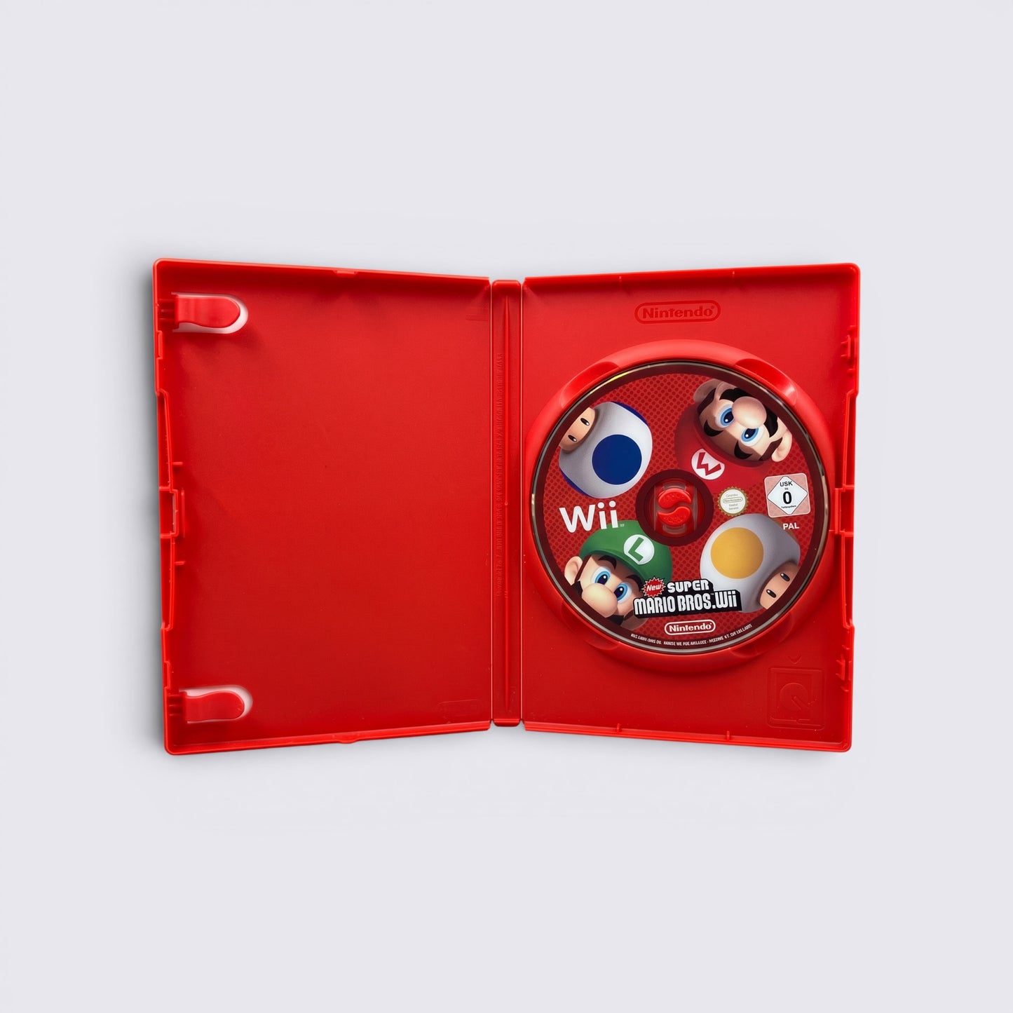 MrPixel New Super Mario Bros. Wii game disc inside a red plastic case featuring Mario, Luigi, and Toad characters.