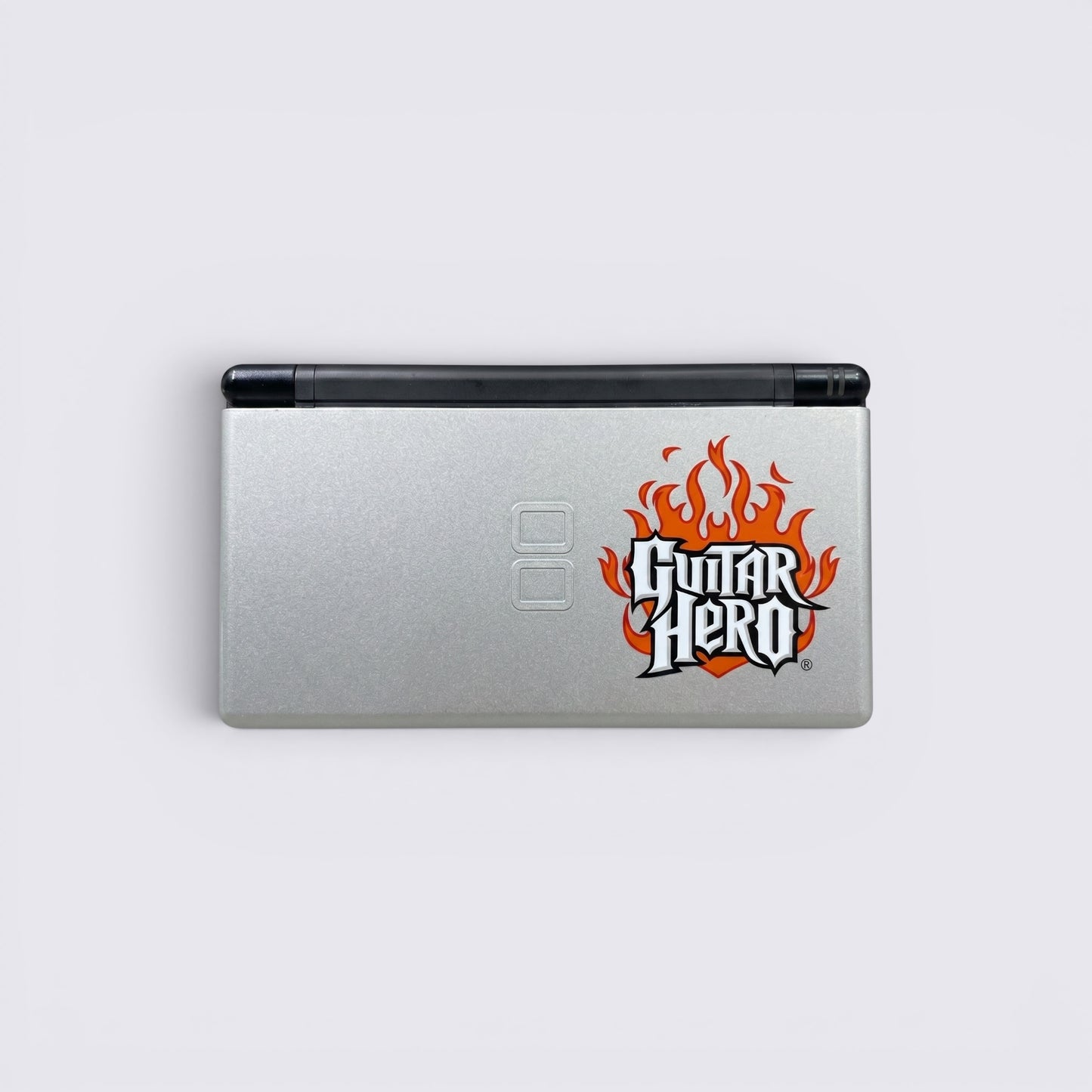 MrPixel Nintendo DS Lite Guitar Hero Edition console in silver with iconic flame logo on the lid