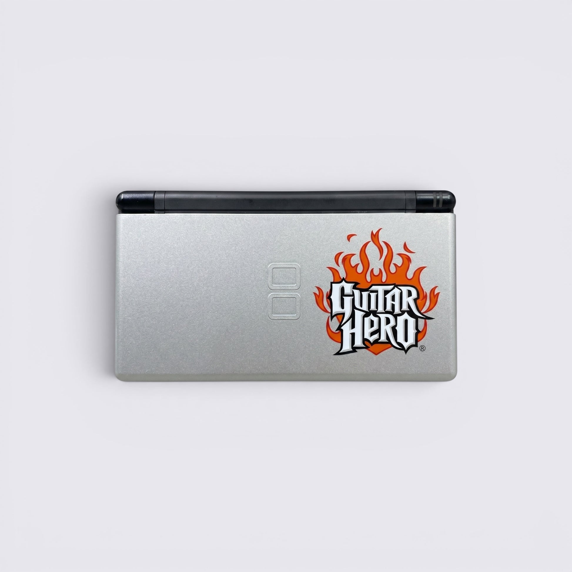 MrPixel Nintendo DS Lite Guitar Hero Edition console in silver with iconic flame logo on the lid