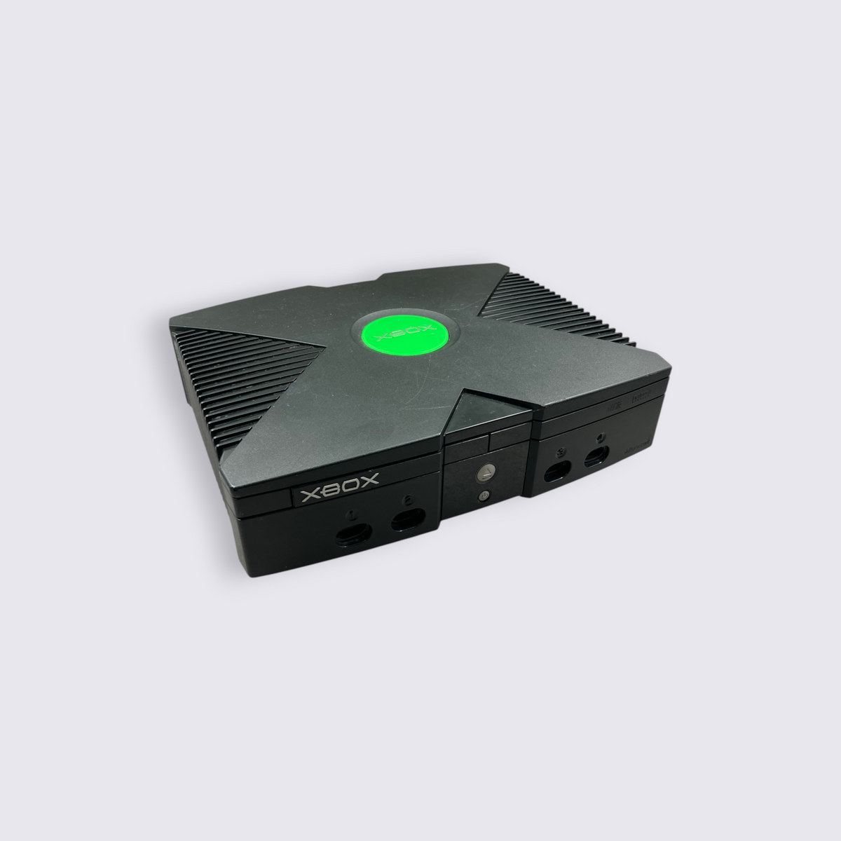 MrPixel original black Xbox console with iconic green logo on a grey surface