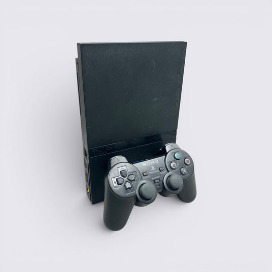 MrPixel black PlayStation 2 Slim console standing upright with a matching wired DualShock 2 controller in front