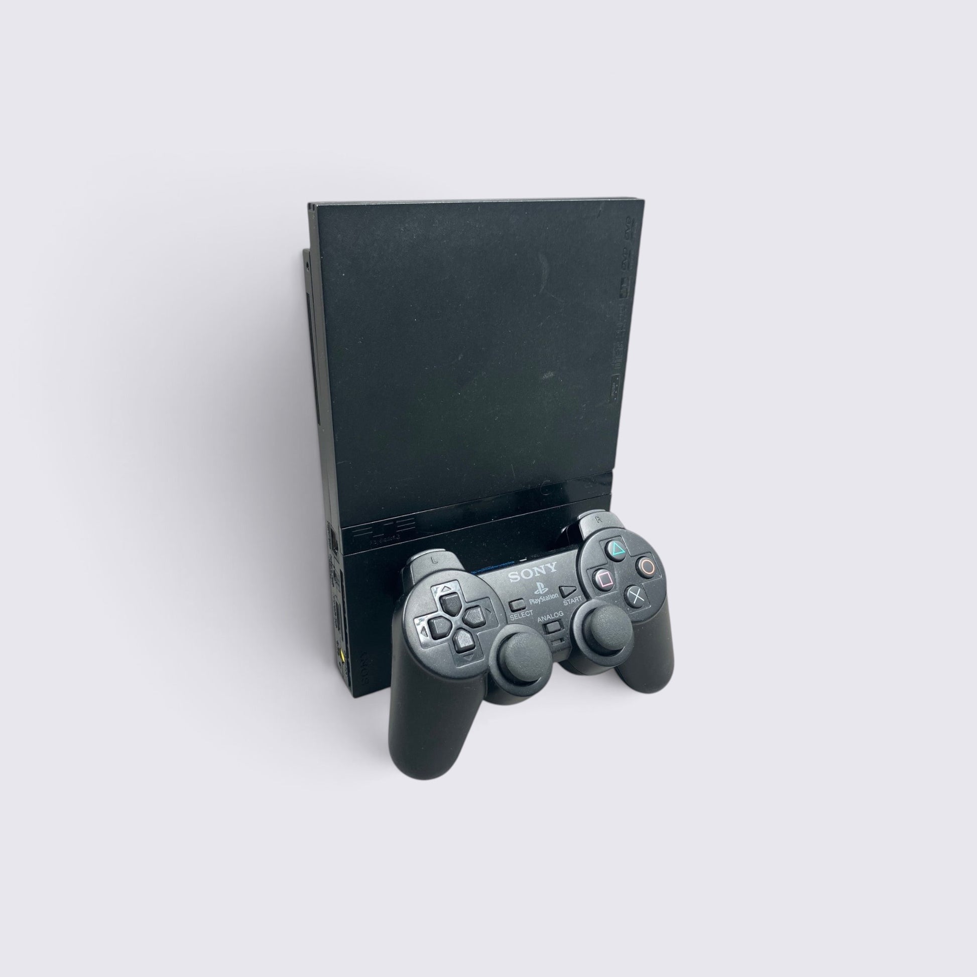MrPixel black PlayStation 2 Slim console standing upright with a matching black DualShock 2 controller in front.