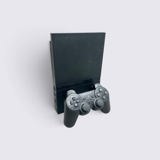 MrPixel black PlayStation 2 Slim console standing upright with a matching black DualShock 2 controller in front.