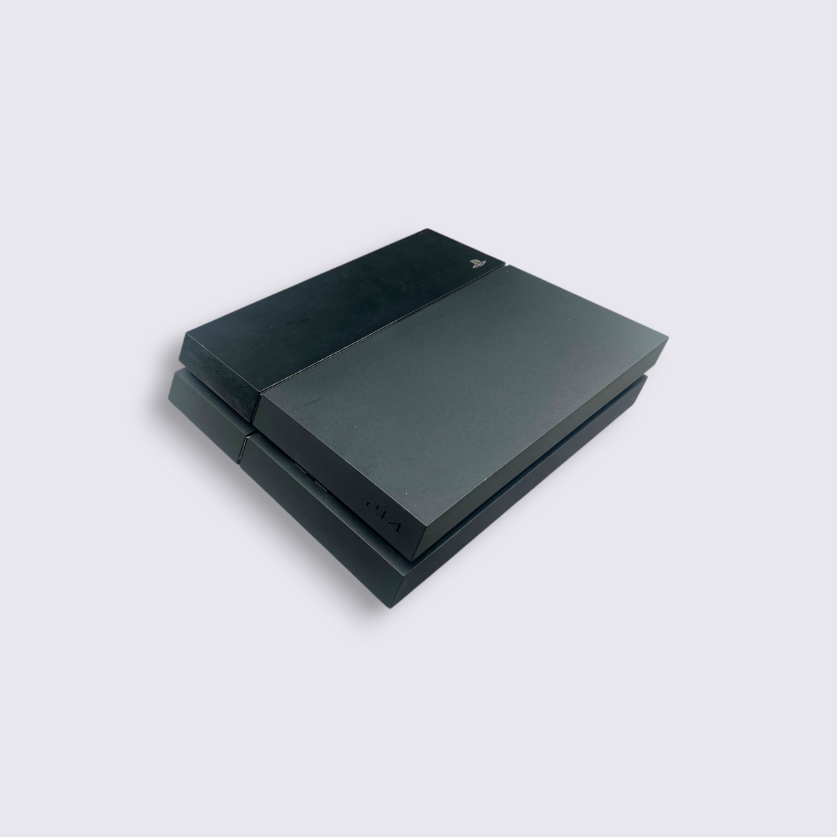 MrPixel original black PlayStation 4 fat console with iconic angular design on a grey surface