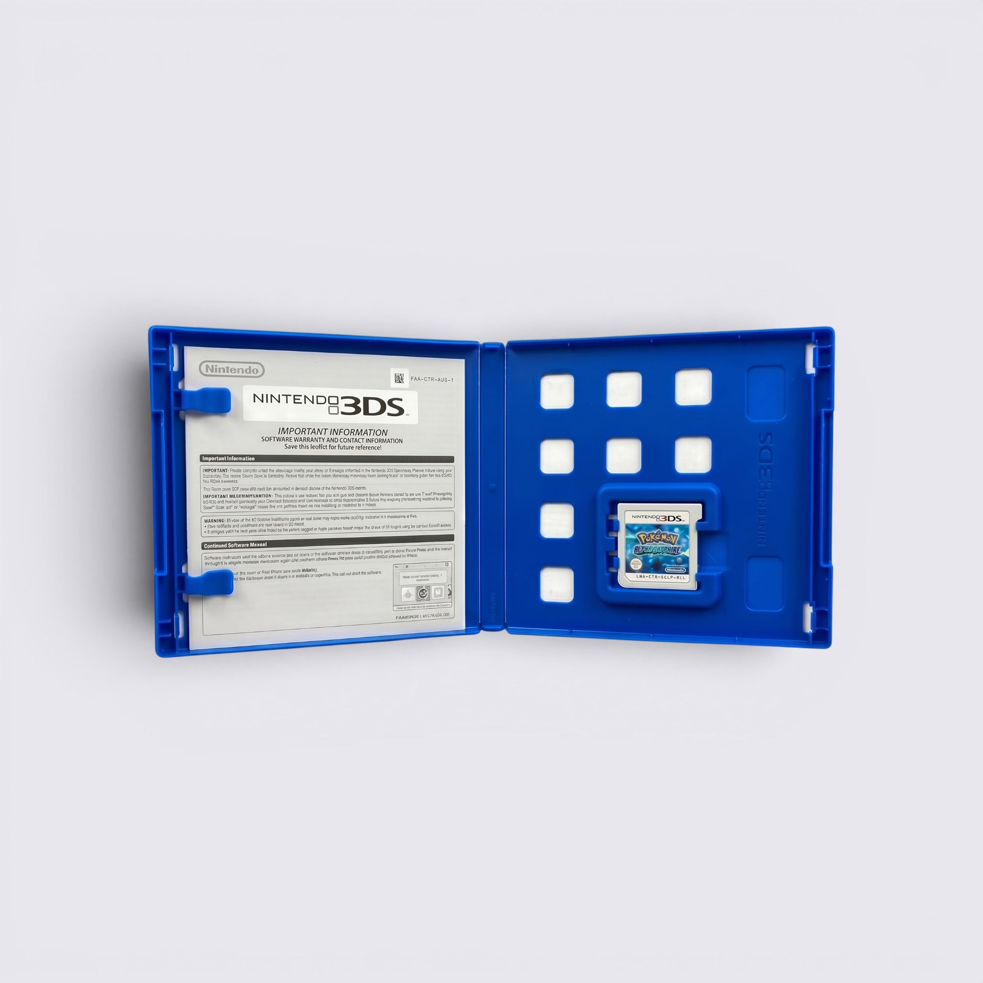 MrPixel Pokemon Alpha Sapphire Nintendo 3DS game cartridge inside a blue plastic storage case with instruction manual.