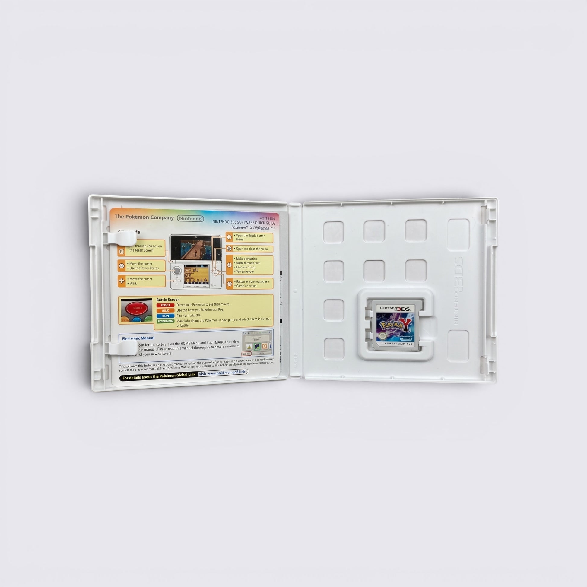 MrPixel Pokemon Y Nintendo 3DS game cartridge inside an open white plastic case with a quick start guide insert.