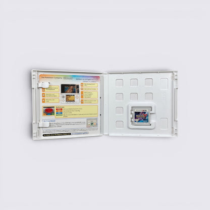 MrPixel Pokemon Y Nintendo 3DS game cartridge inside an open white plastic case with a quick start guide insert.