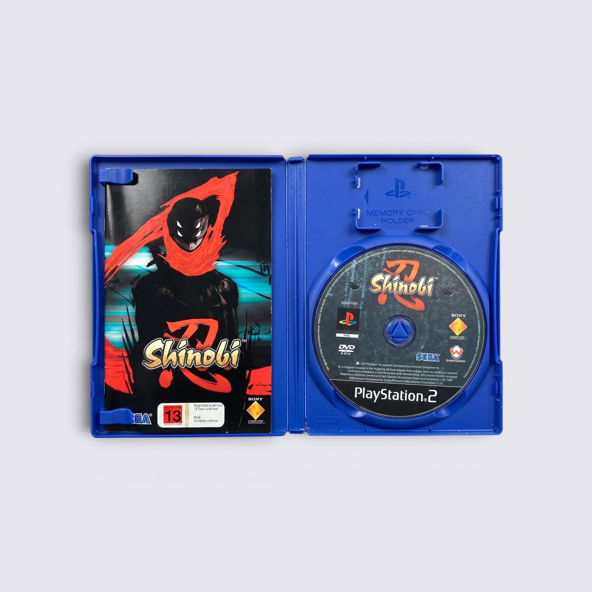 MrPixel Shinobi PlayStation 2 game case open showing the disc and cover art featuring a stylized ninja character.