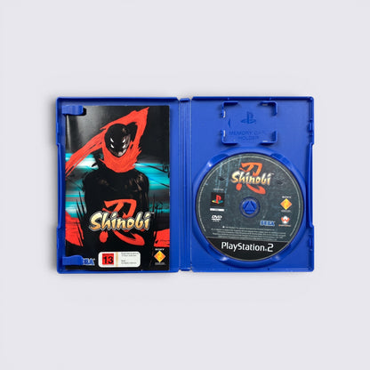 MrPixel Shinobi PlayStation 2 game case open showing the disc and cover art featuring a stylized ninja character.
