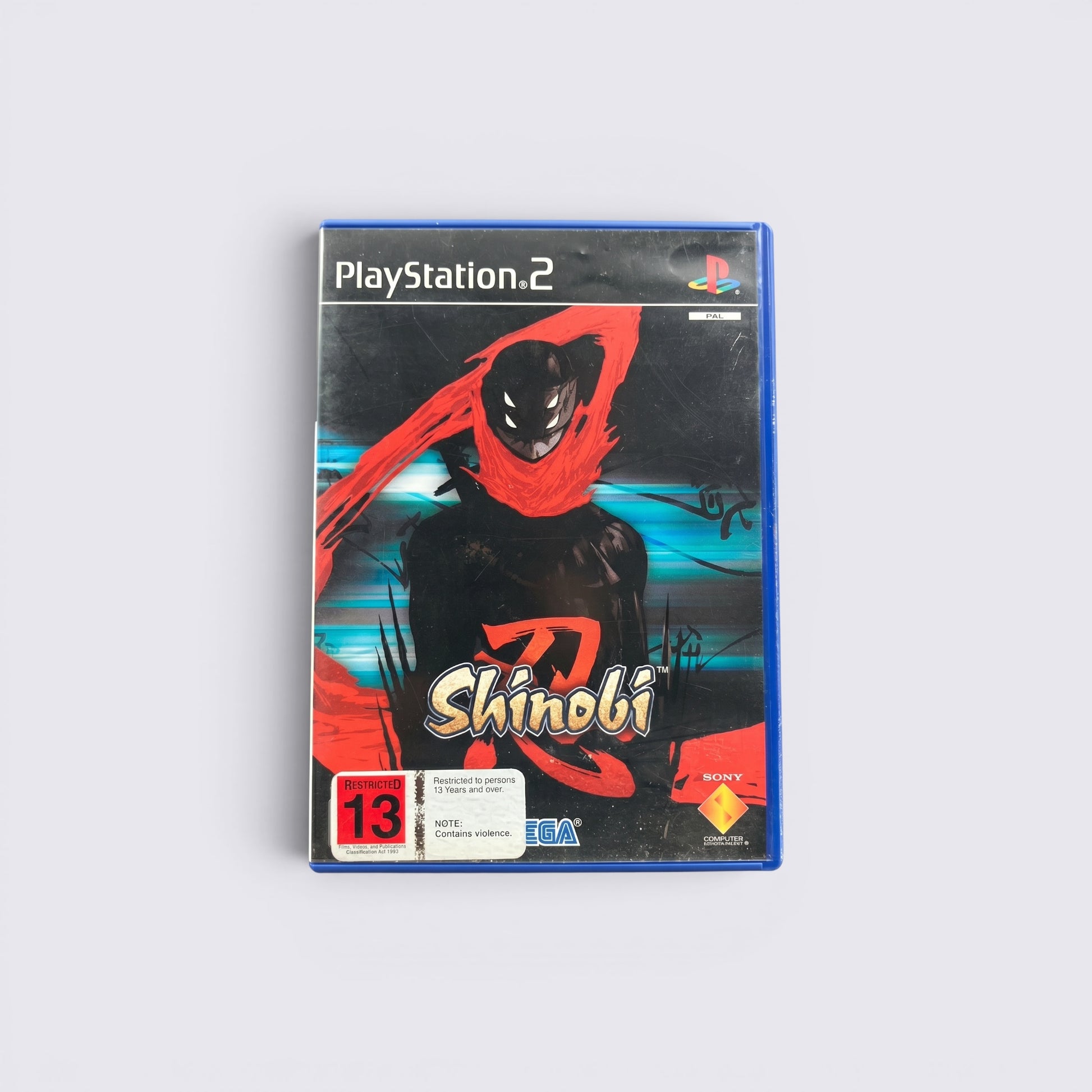 MrPixel Shinobi PlayStation 2 game case featuring a stylized ninja character with a red scarf on a black background.
