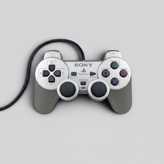 MrPixel silver Sony PlayStation 2 DualShock 2 wired controller with dual analogue sticks and iconic button layout.