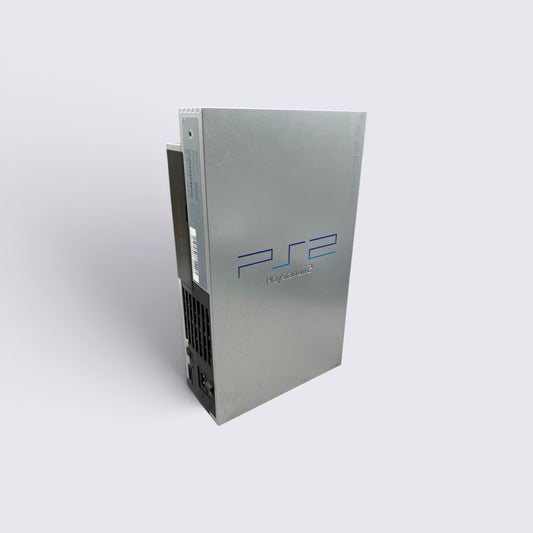 MrPixel silver PlayStation 2 fat console standing vertically, showcasing the iconic PS2 logo and sleek metallic finish.