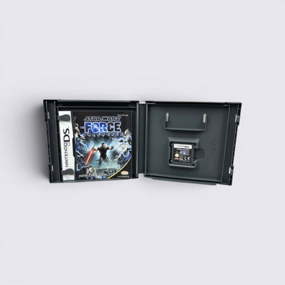 MrPixel Star Wars The Force Unleashed Nintendo DS game case with cartridge and manual open on a grey surface