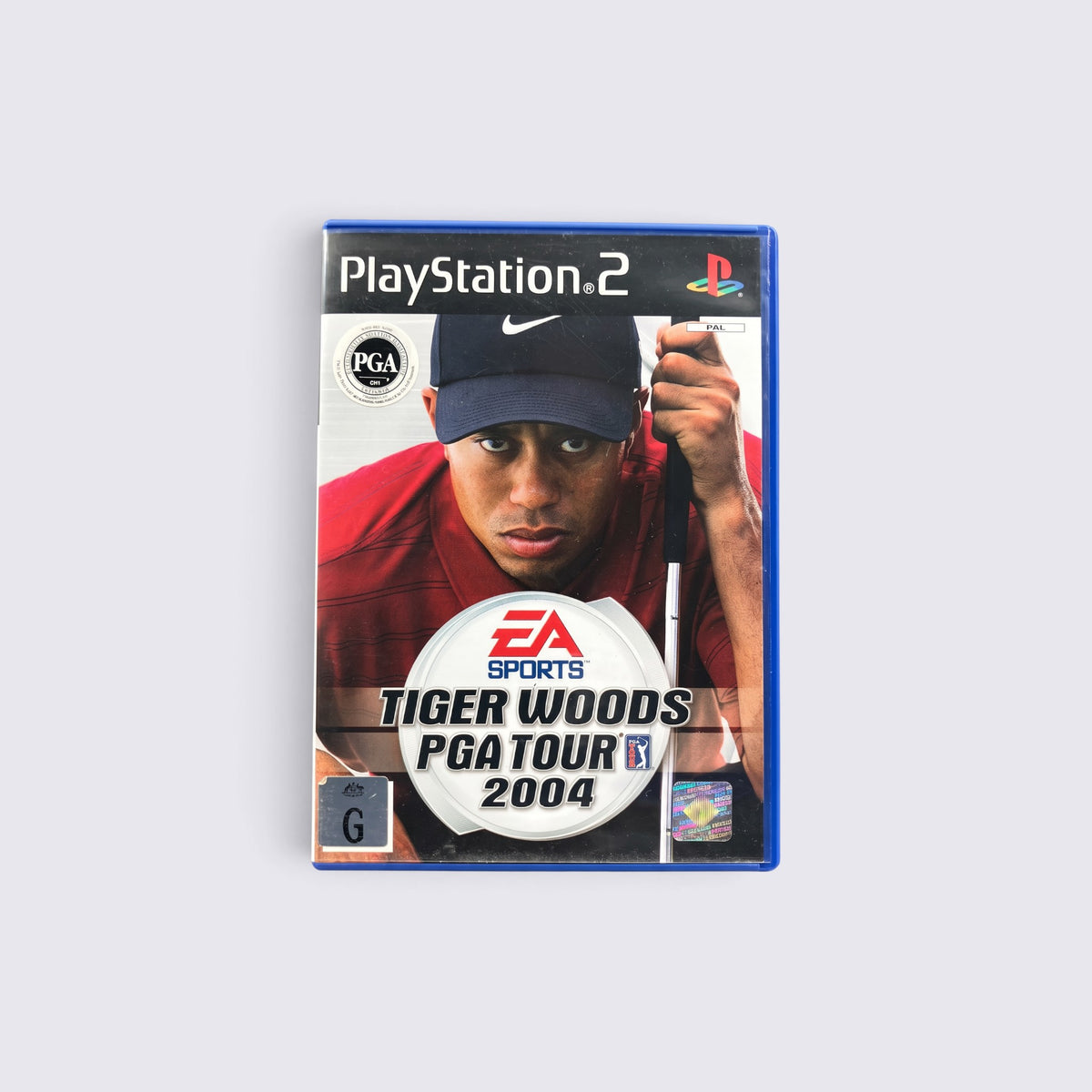 MrPixel Tiger Woods PGA Tour 2004 PlayStation 2 game case featuring Tiger Woods in a red shirt and navy cap.