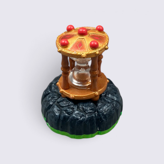 MrPixel Time Twister collectible magic item from Skylanders Spyro’s Adventure with gold, red, and rocky base details.