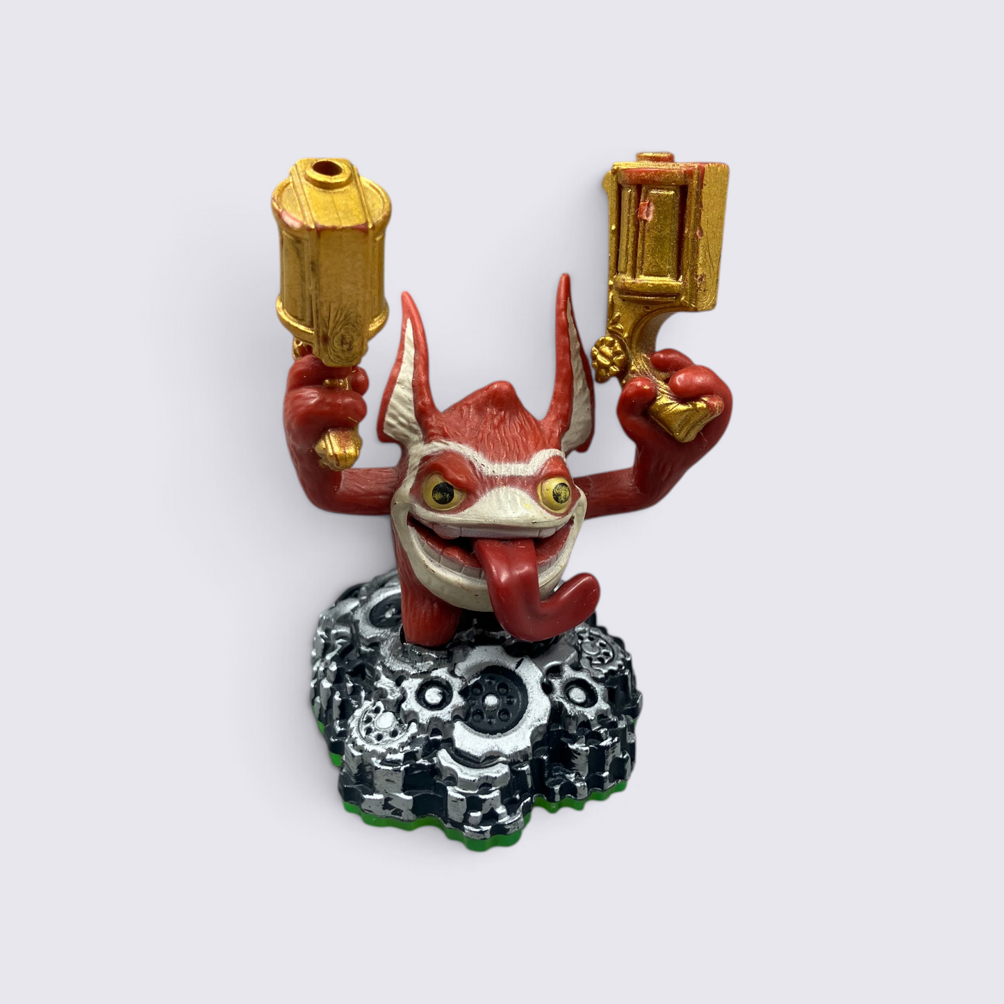 MrPixel Trigger Happy Skylander figure holding twin golden guns on a metallic gear base
