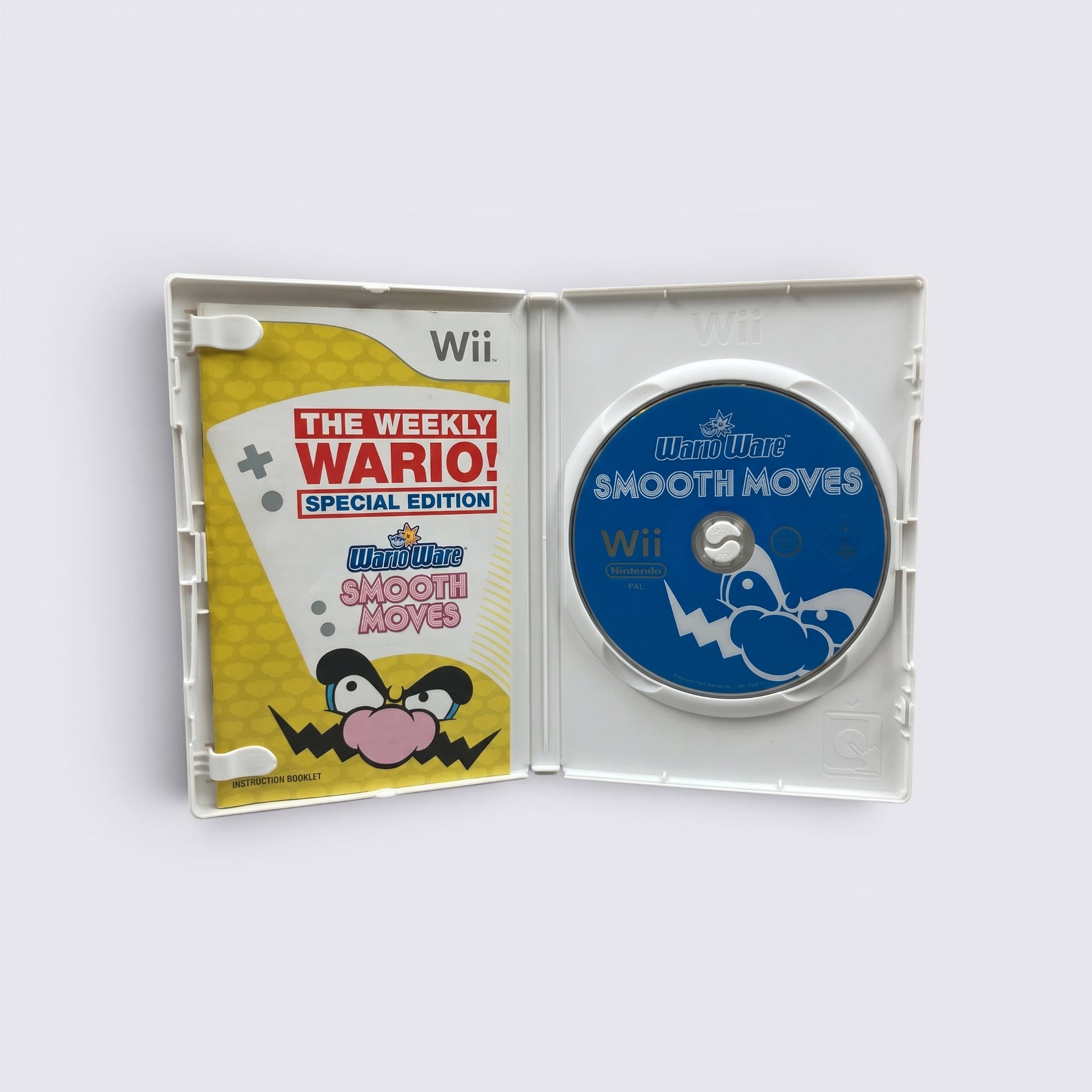 MrPixel WarioWare Smooth Moves Wii game case open with instruction booklet and blue game disc inside