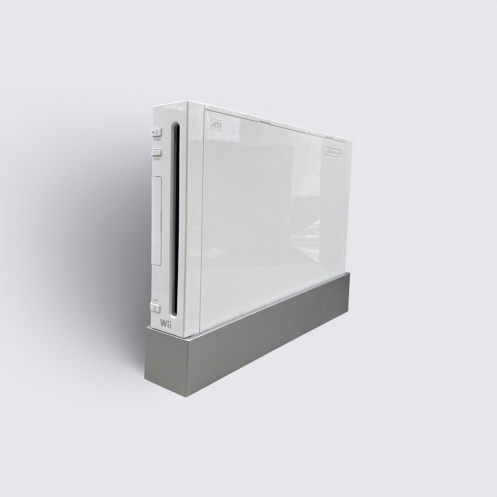 MrPixel white Nintendo Wii home gaming console standing vertically on a grey base against a neutral background