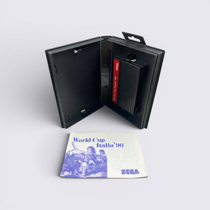MrPixel World Cup Italia 90 Sega game cartridge in black case with original instruction manual on grey surface