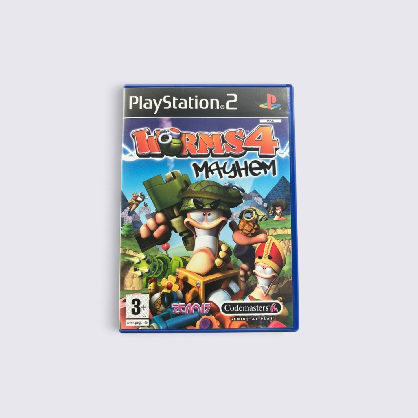 MrPixel Worms 4: Mayhem PlayStation 2 game case featuring cartoon worms in combat gear on a destructible landscape.