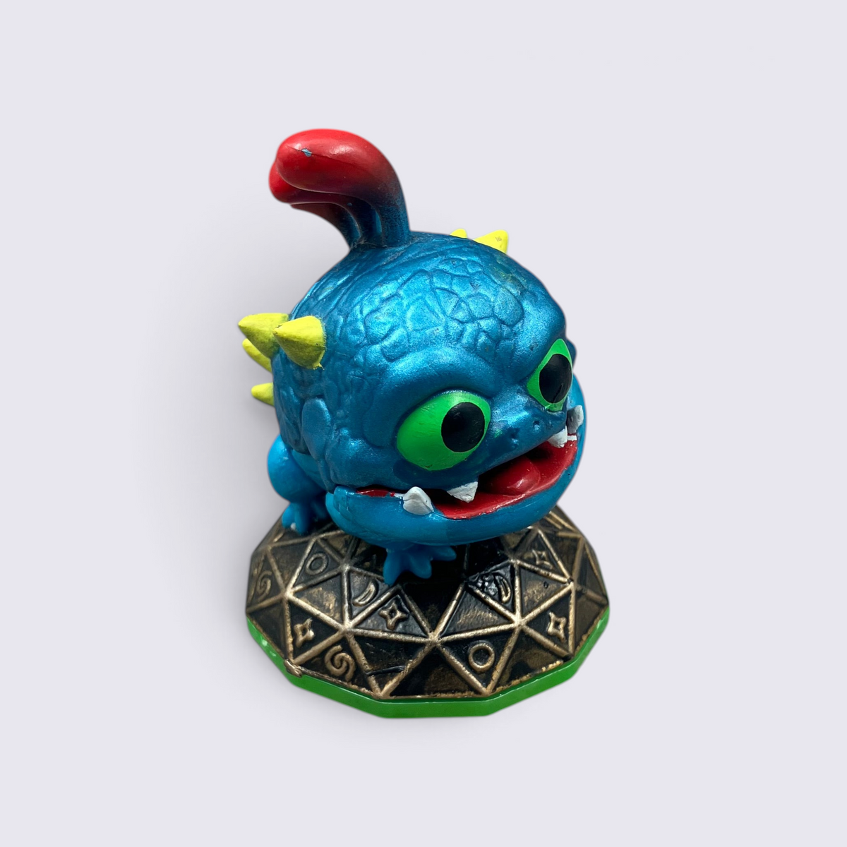 MrPixel Wrecking Ball Skylander figure with blue textured skin, green eyes, and red tongue on a geometric base