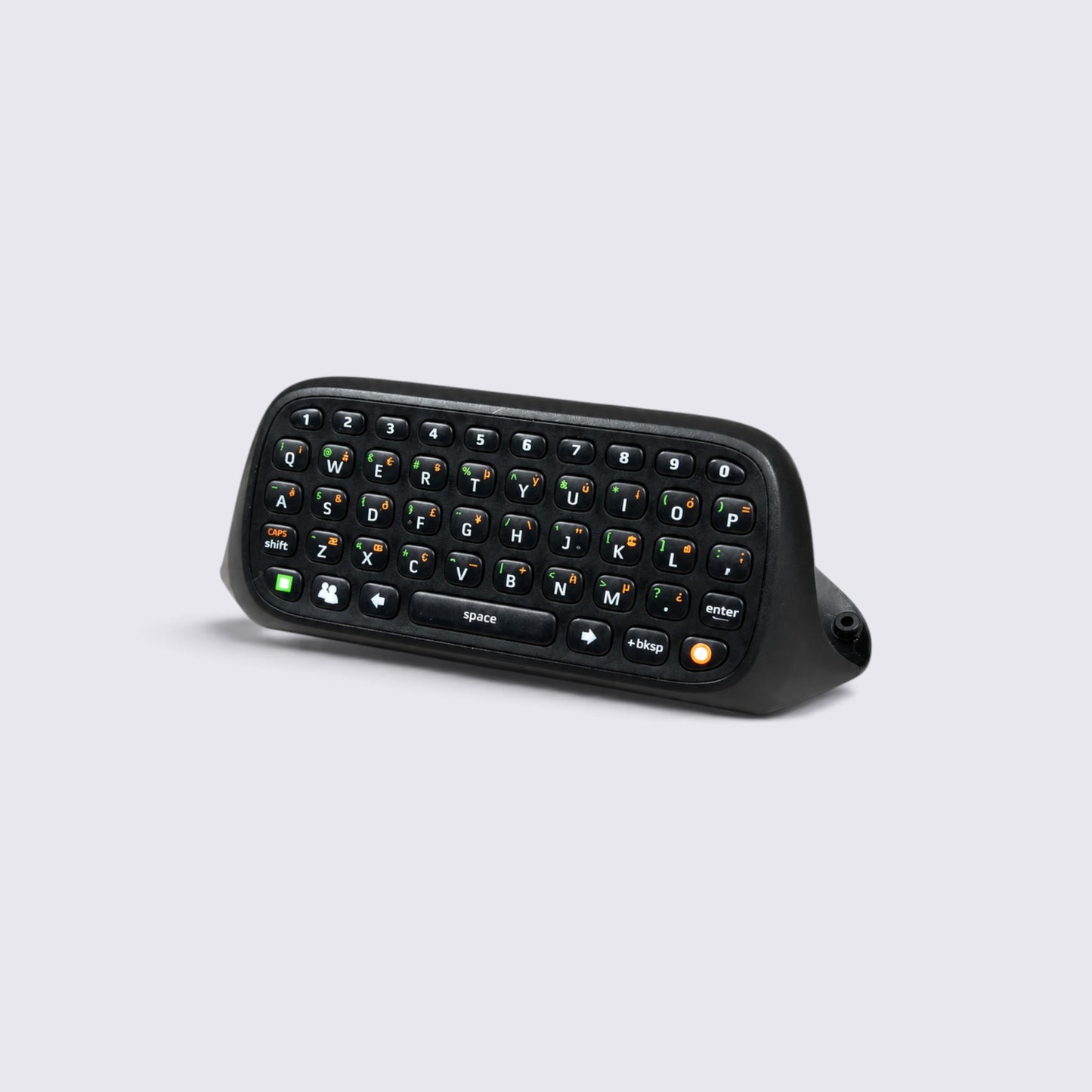 MrPixel Xbox 360 Chatpad black QWERTY keyboard attachment for wireless gaming controllers on a light grey background