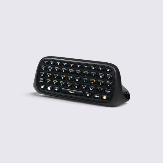 MrPixel Xbox 360 Chatpad black QWERTY keyboard attachment for wireless gaming controllers on a light grey background