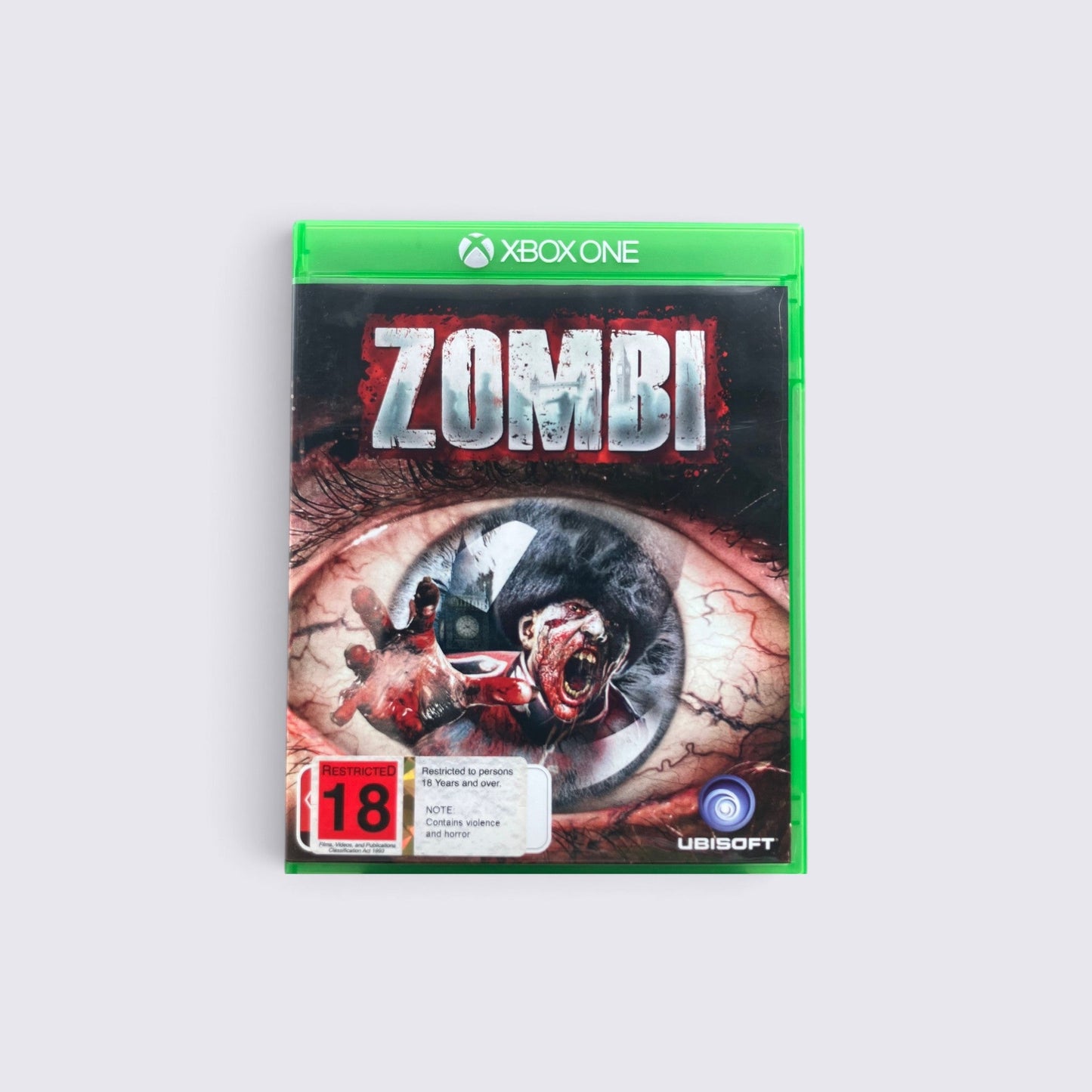 MrPixel ZOMBI survival horror game for Xbox One featuring a graphic zombie eye cover art with an 18 rating label.